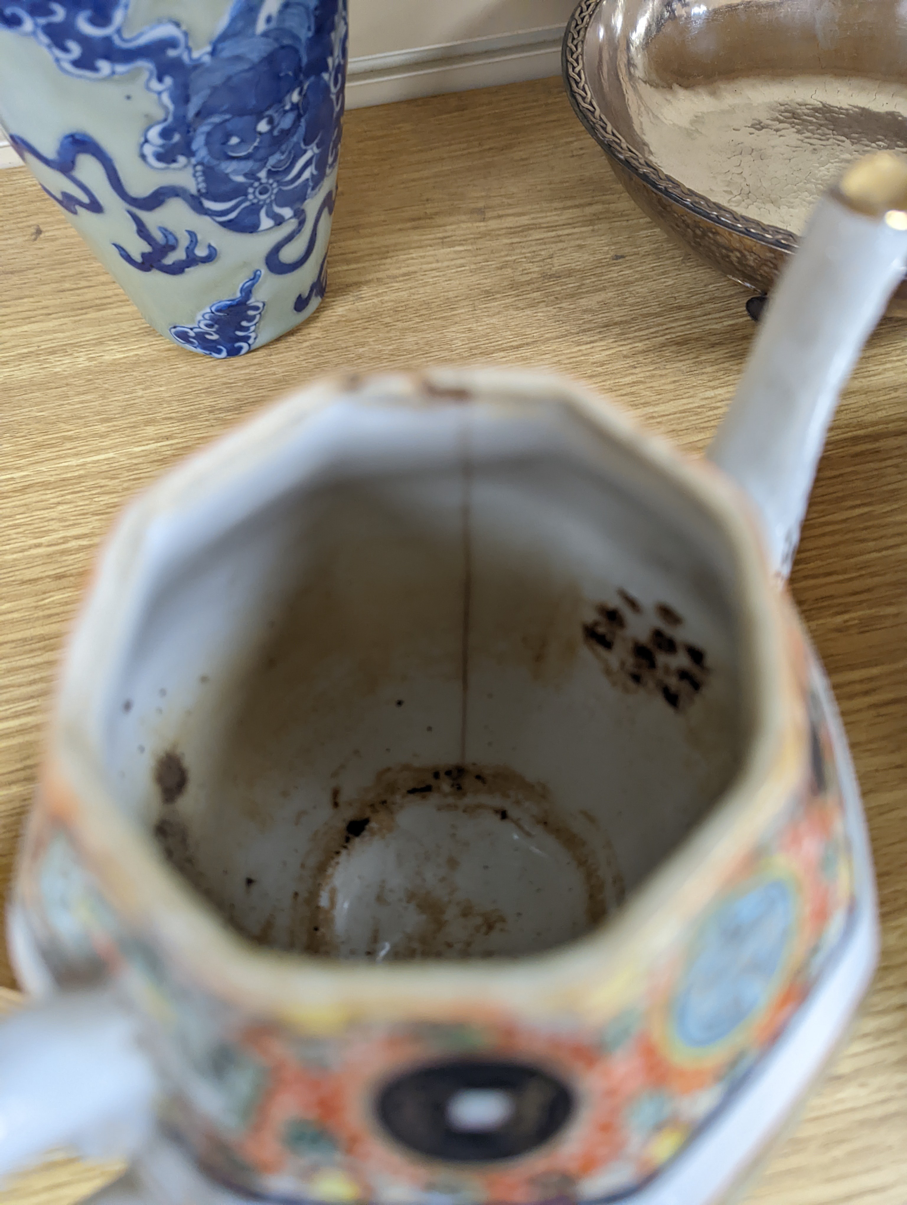 A Chinese celadon glazed vase, 24cm and a Chinese famille rose teapot and matching cream jug, a.f.